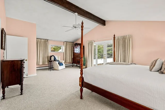 a bedroom with furniture and a large window