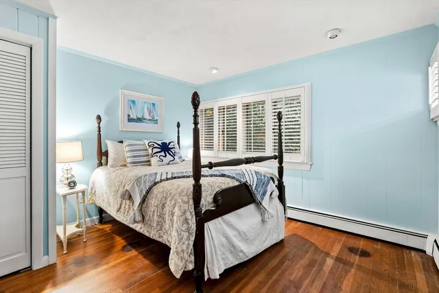 a bed sitting in a bedroom next to a window