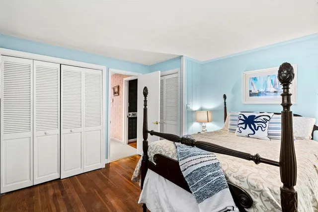 a bedroom with furniture and wooden floor