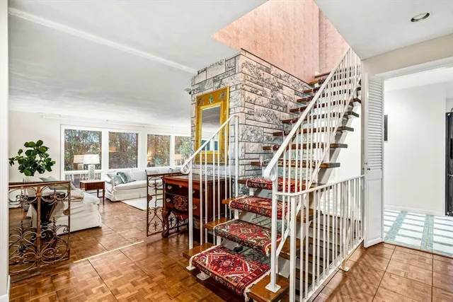 a view of entryway livingroom and hall with wooden floor