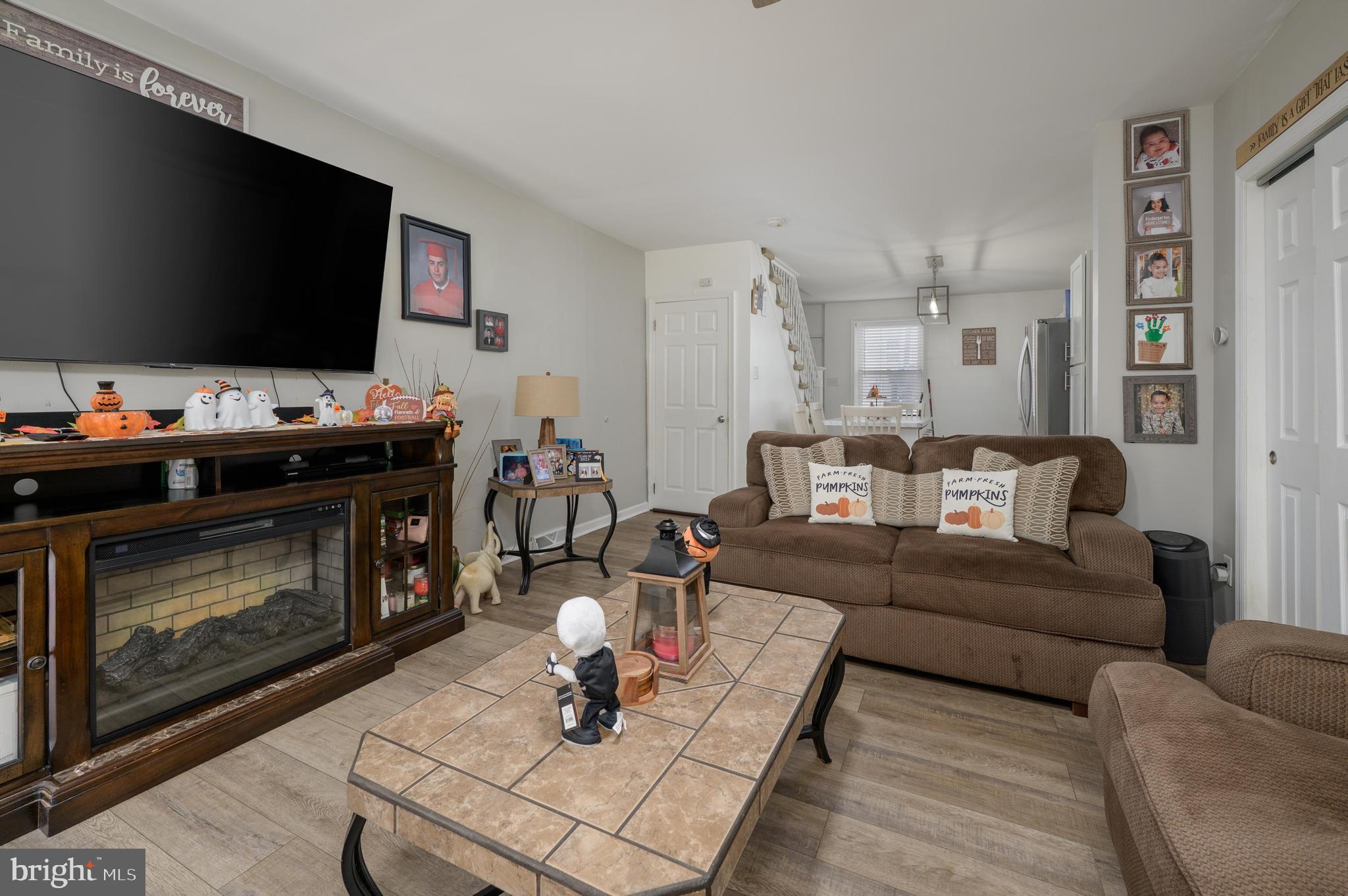 103 Middlesex Street Gloucester City, NJ 08030 - Photo 3 of 31 a living room with furniture a flat screen tv and a fireplace