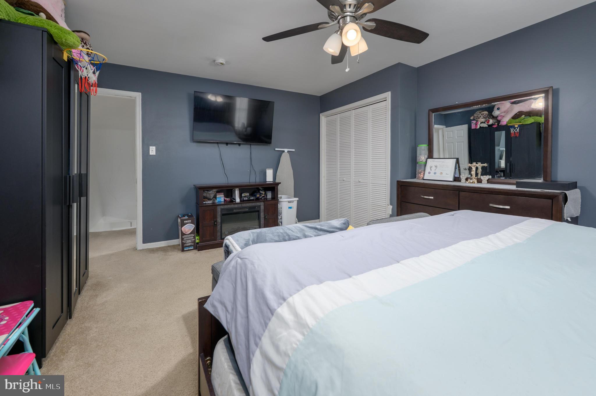 103 Middlesex Street Gloucester City, NJ 08030 - Photo 9 of 31 a bedroom with a bed and a flat tv screen on dresser