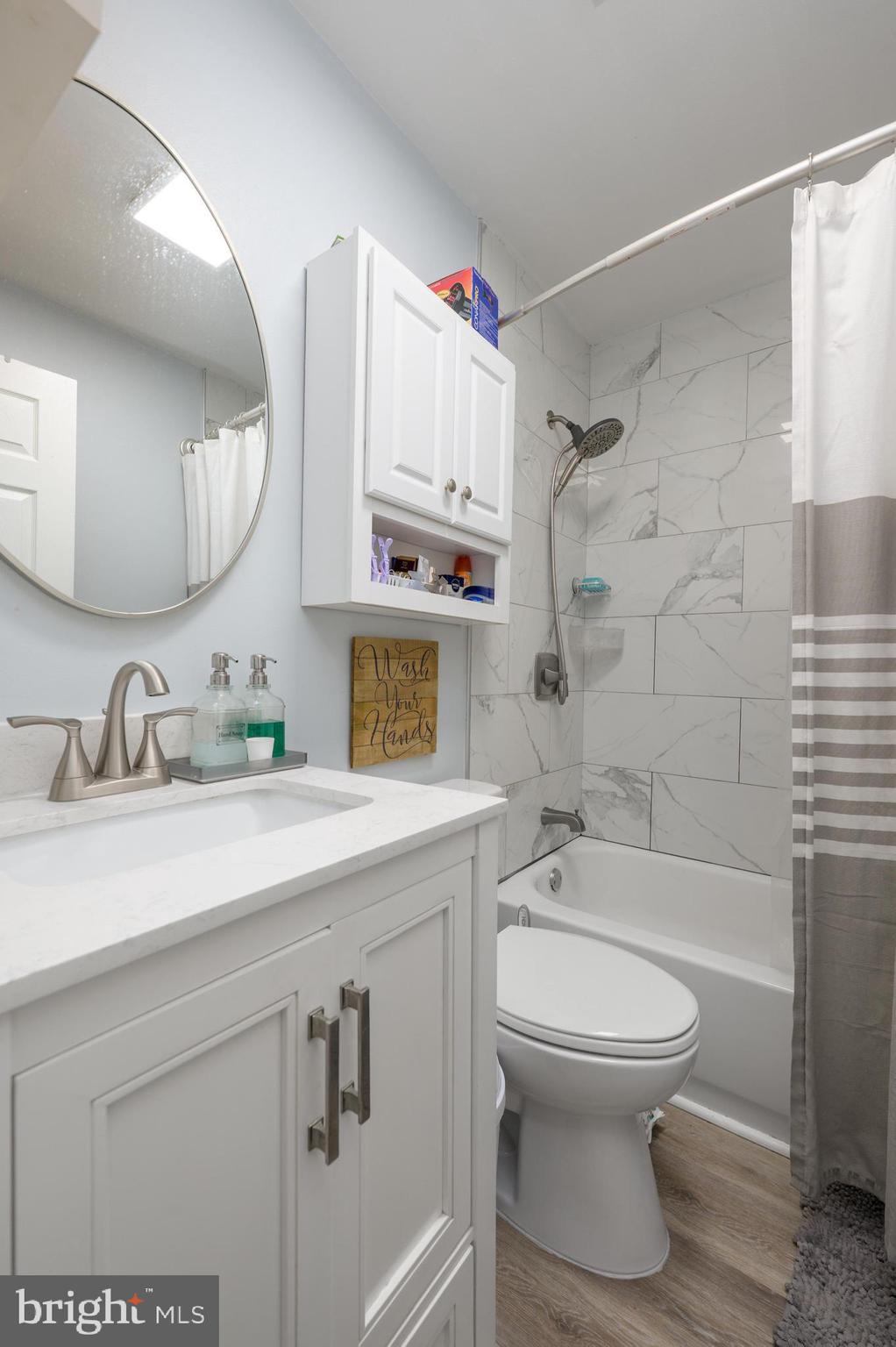 103 Middlesex Street Gloucester City, NJ 08030 - Photo 10 of 31 a bathroom with a sink a toilet and a mirror