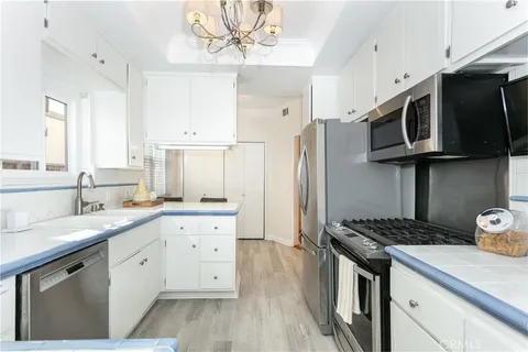 a kitchen with stainless steel appliances a sink stove and refrigerator