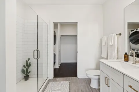a bathroom with a sink toilet and shower