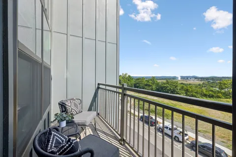 a view of a balcony with chair and table