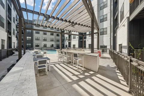a view of a patio with dining table and chairs with wooden floor and fence