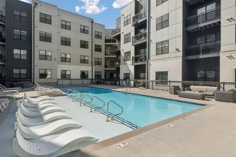 a swimming pool with outdoor seating and yard