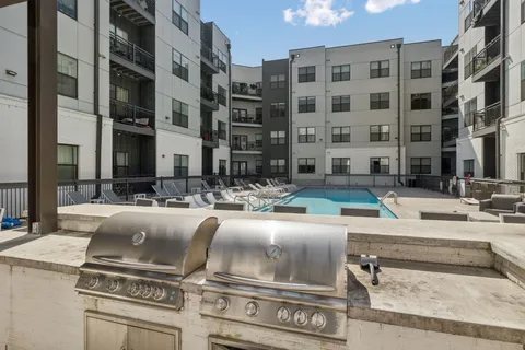 a view of a building with cars parked