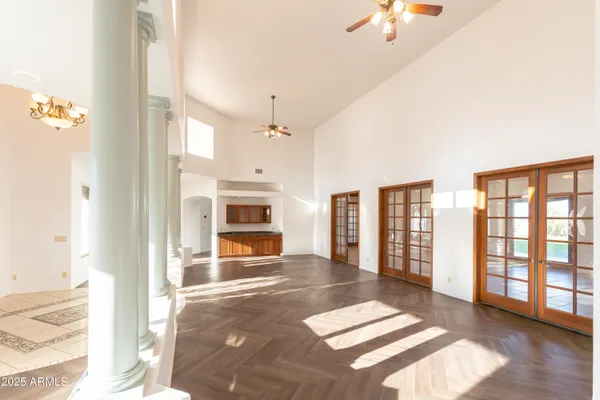 an empty room with fan and windows