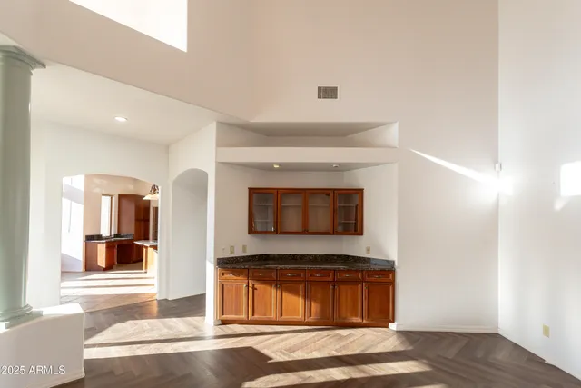 a bathroom with a granite countertop sink and a large mirror