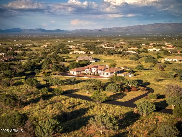 a view of gallery with chandelier and glass door