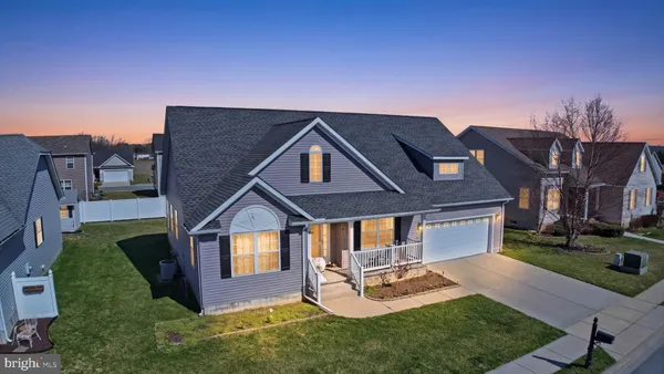 a front view of house with yard and outdoor seating