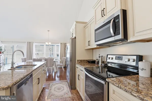 a kitchen with stainless steel appliances granite countertop a stove and a sink