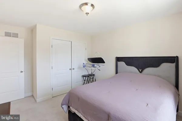 a bedroom with a bed and cabinets