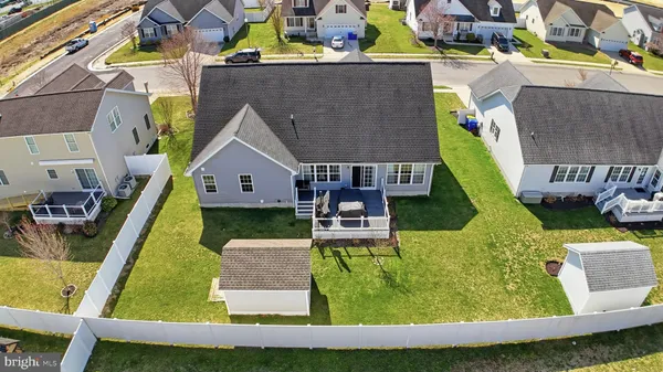 an aerial view of a house with a garden and swimming pool