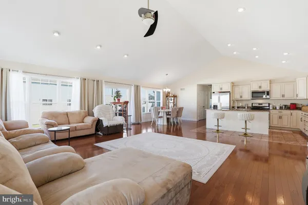 a living room with furniture and a view of kitchen