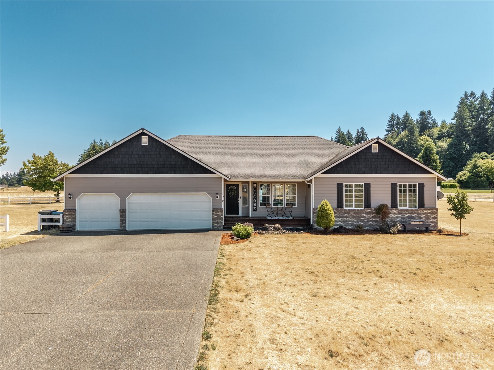 9519 184th Avenue Southwest Rochester, WA 98579 - Photo 1 of 38 a front view of a house with yard and garage