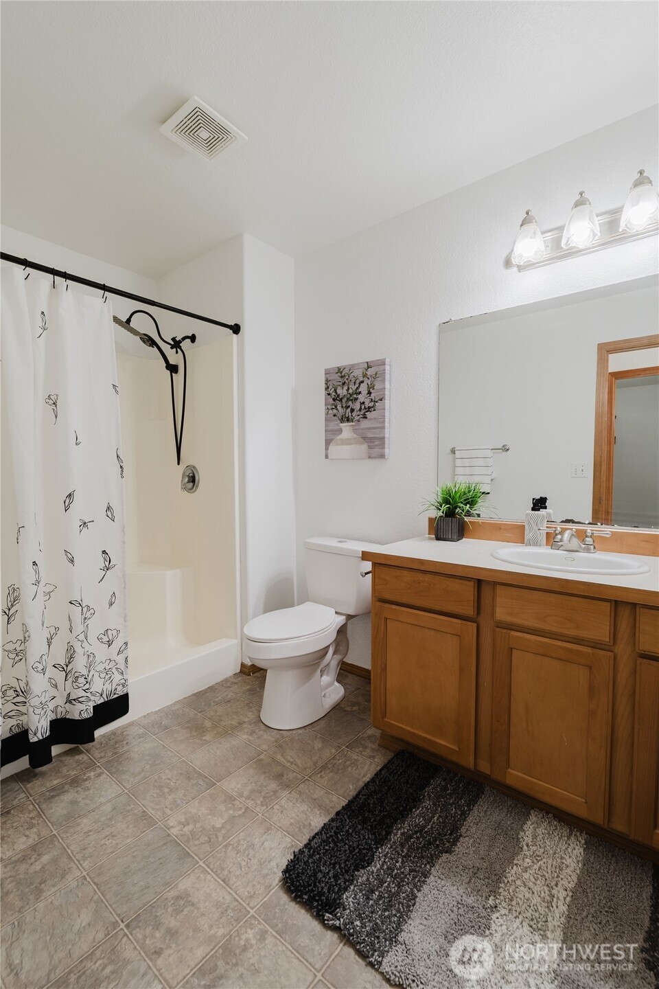 9519 184th Avenue Southwest Rochester, WA 98579 - Photo 23 of 38 a spacious bathroom with a double vanity sink a toilet and a shower