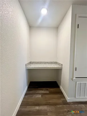 a view of room with wooden floor