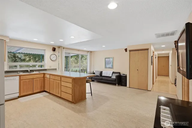 a large white room with granite countertop furniture and a large window