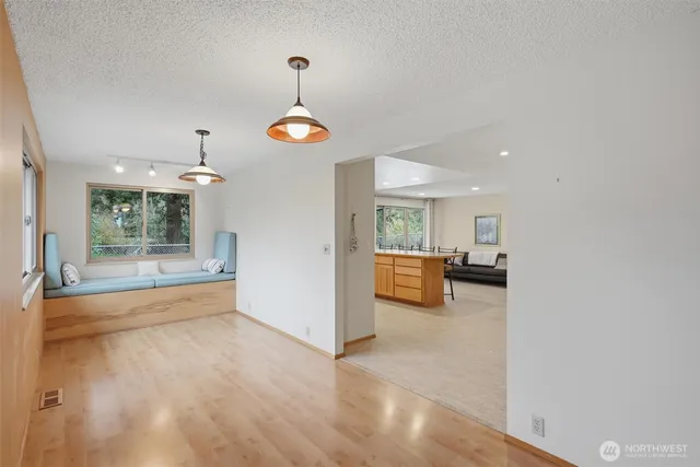 a kitchen with stainless steel appliances white cabinets and a refrigerator