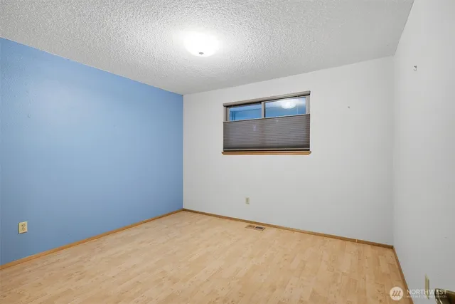 an empty room with windows and closet