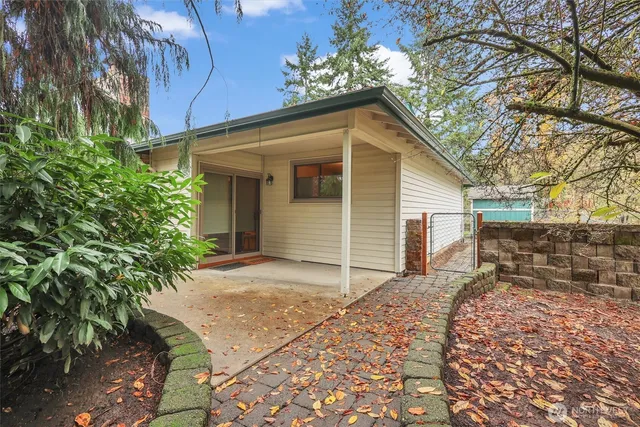 an aerial view of lake residential house with swimming pool and green space