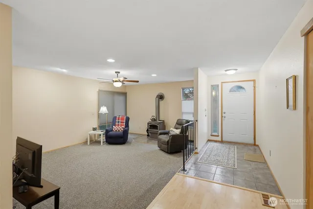 a living room with furniture and a chandelier