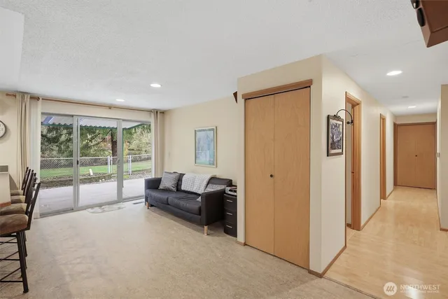 a living room with furniture and large windows