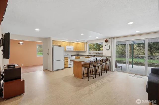 a open kitchen with stainless steel appliances granite countertop a refrigerator and a sink