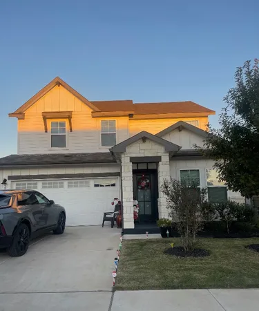 a couple of cars parked in front of a house