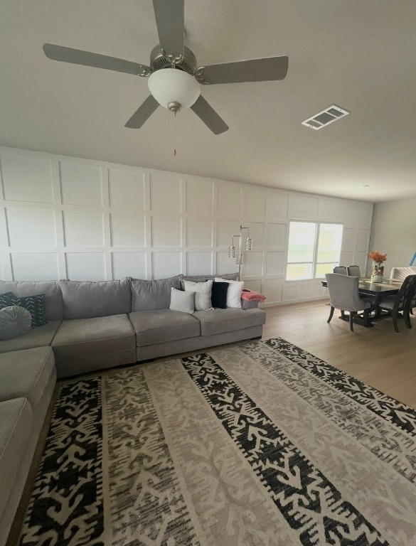 2917 Mill Run Bend Round Rock, TX 78665 - Photo 3 of 8 Living area featuring light wood-style floors and a ceiling fan