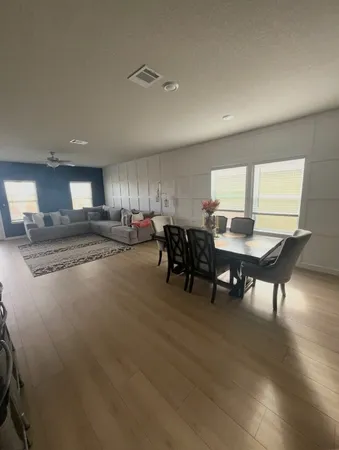 a view of a dining room with furniture and a livingroom