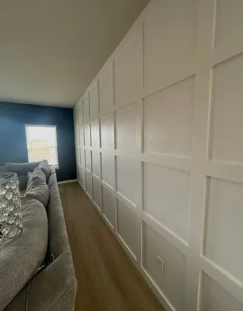 a spacious bedroom with a bed and a chandelier