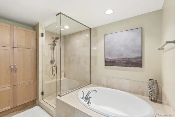 a white bath tub sitting next to a shower