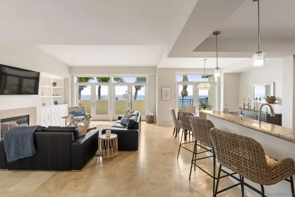 a living room with furniture a flat screen tv and a large window