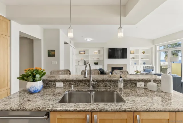 a kitchen with kitchen island granite countertop a counter top space appliances and cabinets