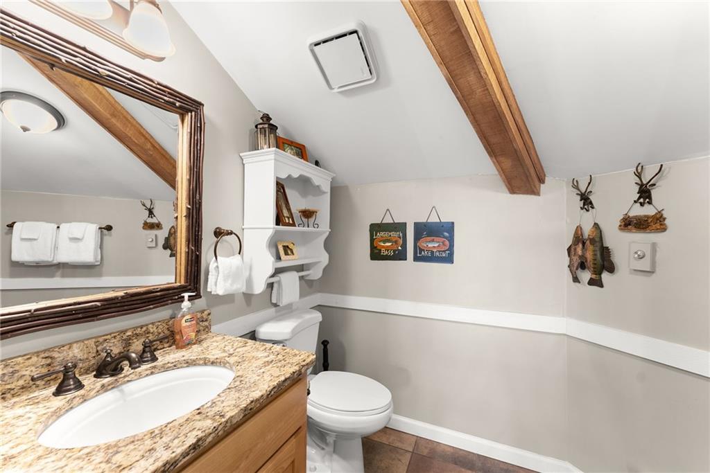 28 Little Hendricks Mountain Road Jasper, GA 30143 - Photo 16 of 50 a bathroom with a granite countertop sink mirror vanity and toilet