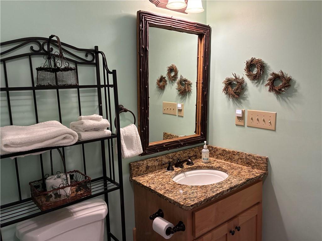 28 Little Hendricks Mountain Road Jasper, GA 30143 - Photo 25 of 42 a bathroom with a granite countertop sink and a mirror