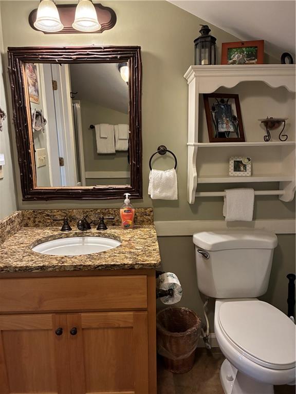 28 Little Hendricks Mountain Road Jasper, GA 30143 - Photo 31 of 42 a bathroom with a granite countertop toilet sink and mirror