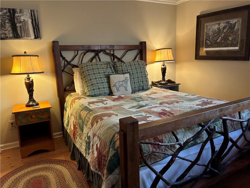 28 Little Hendricks Mountain Road Jasper, GA 30143 - Photo 36 of 42 a bed sitting in a bedroom next to a lamp