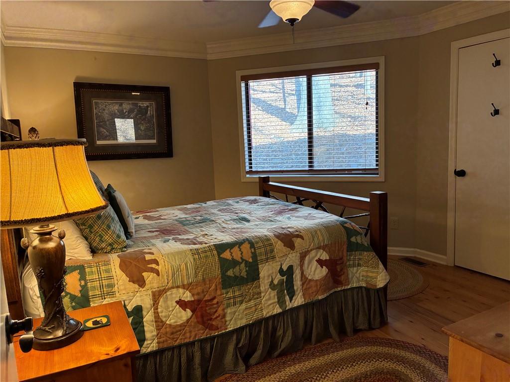 28 Little Hendricks Mountain Road Jasper, GA 30143 - Photo 37 of 42 a bedroom with a bed and wooden floor