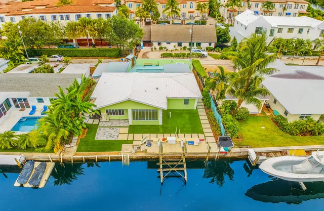 an aerial view of a house with a swimming pool patio and outdoor seating