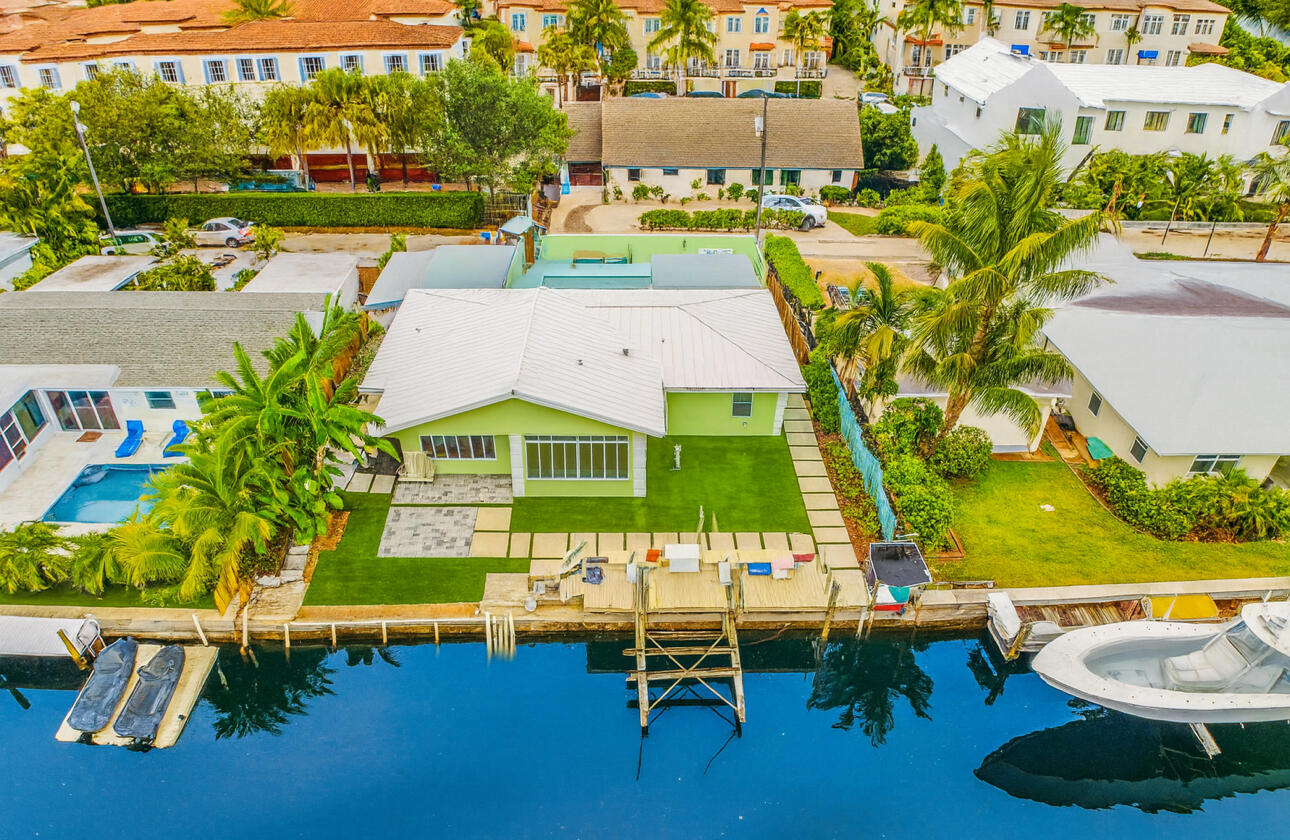 810 Bamboo Lane Delray Beach, FL 33483 - Photo 1 of 30 an aerial view of a house with a swimming pool patio and outdoor seating