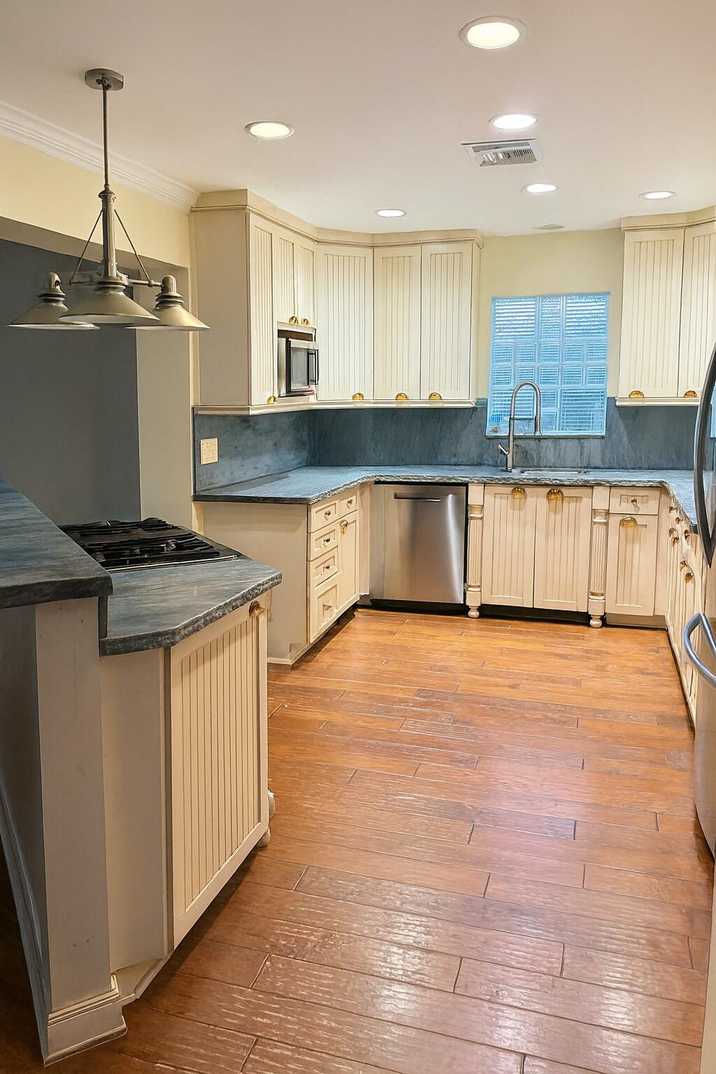 810 Bamboo Lane Delray Beach, FL 33483 - Photo 16 of 30 a kitchen with stainless steel appliances granite countertop a stove a sink and a refrigerator