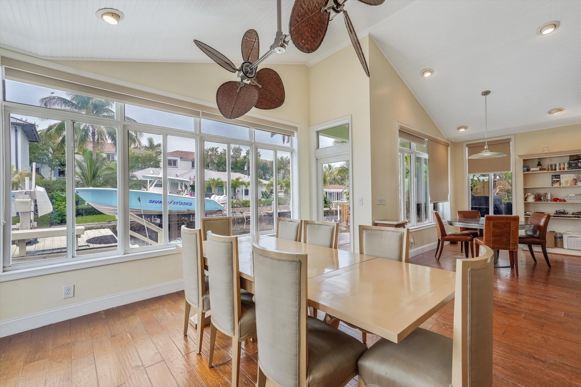 810 Bamboo Lane Delray Beach, FL 33483 - Photo 20 of 30 a view of a dining room and livingroom with furniture wooden floor a chandelier