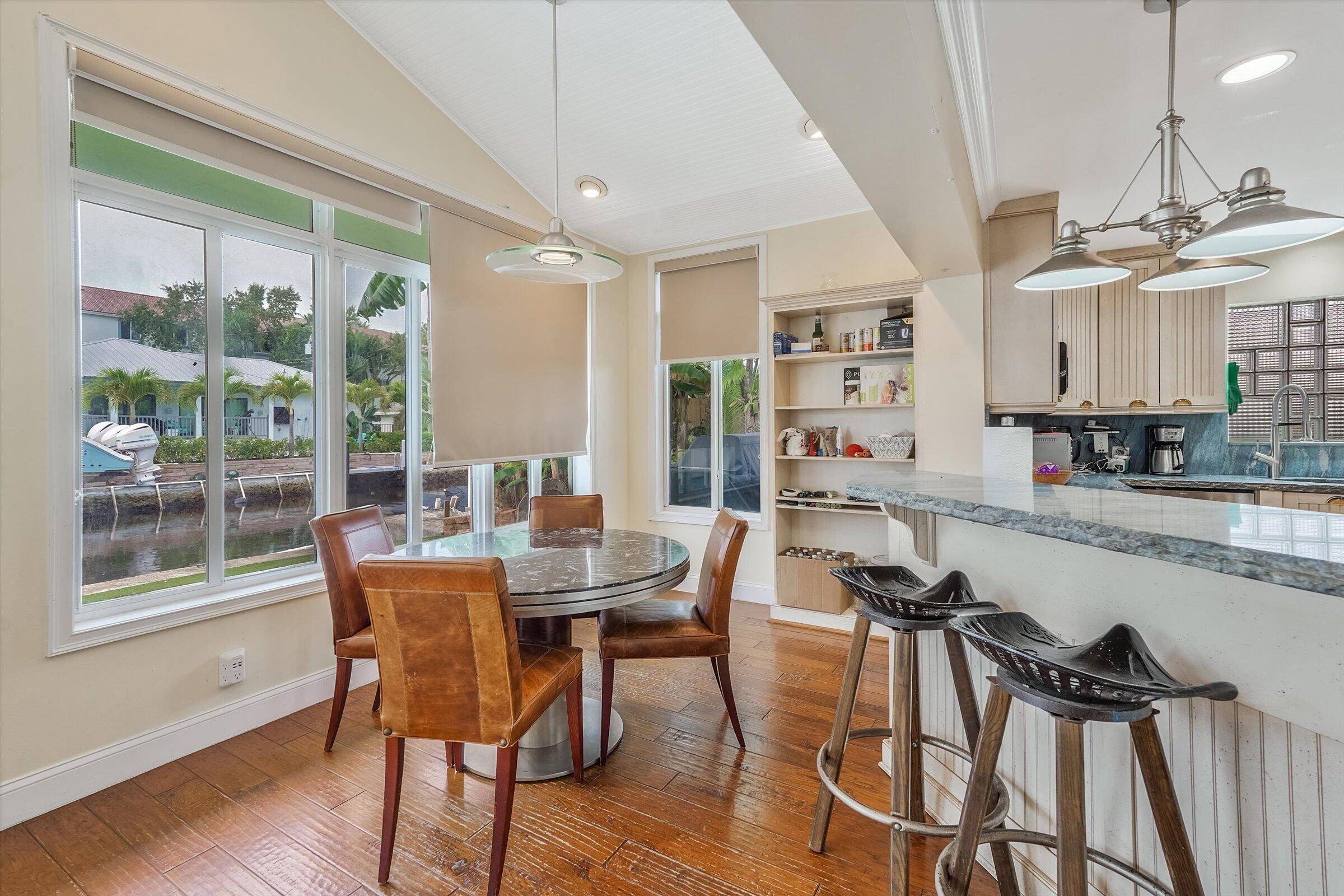 810 Bamboo Lane Delray Beach, FL 33483 - Photo 22 of 30 a view of a dining room with furniture window and wooden floor