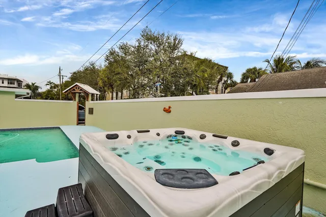 a view of a swimming pool and outdoor seating