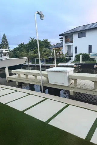 a view of a house with pool and chairs